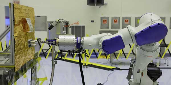 An industrial robot at Kennedy Space Center tests propellant transfer technologies during RROxiTT.
