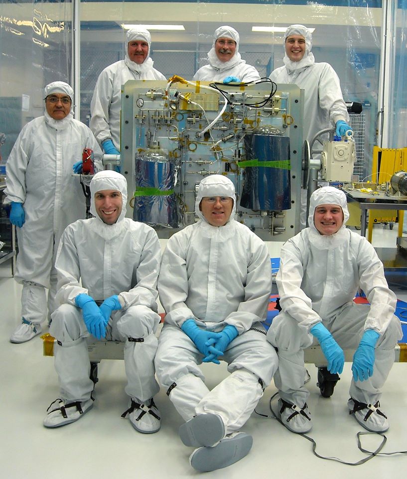 Parker and his colleagues pose for a photo in a cleanroom.<